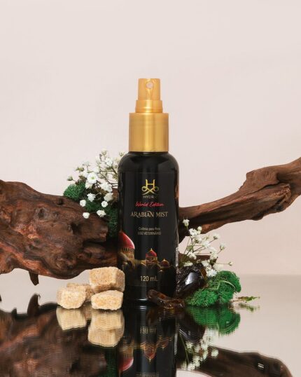 Hydra Arabian Mist pet cologne with driftwood, raw sugar cubes, amber resin and baby's breath on a reflective surface
